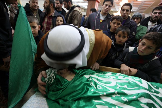 alestinian teenager Muhammad al-Salaymeh is mourned during his funeral in the West Bank city of Hebron, 13 December. Israeli border police occupying Hebron shot the teen dead at a checkpoint on his birthday. @Issam Rimawi / APA images)