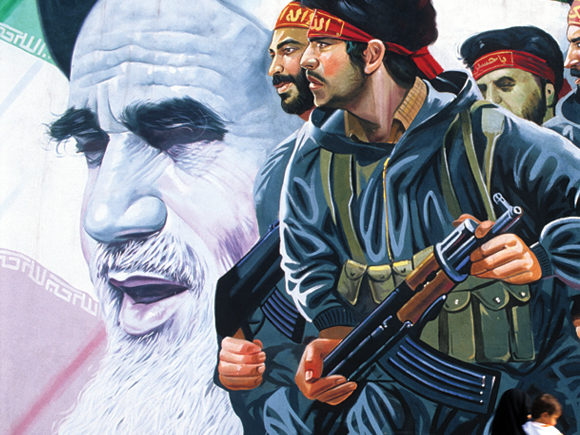 A fusão dos militares e dos religiosos intensificou-se quando estes foram enviados para a frente de batalha e se tornaram comissários ideológicos do novo regime do Ayatollah Khomeini. (Na foto, um mural em Teerão exibe o rosto do fundador da República Islâmica e de elementos da força que ele ajudou a criar). © Getty Images
