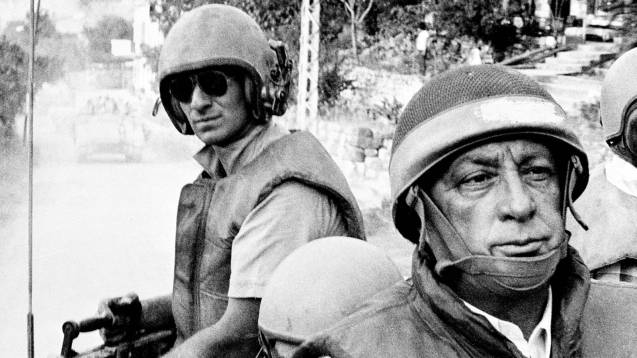 In this June 15, 1982 file picture, Israeli Defence Minister Ariel Sharon, foreground, rides an armored personnel carrier on a tour of Israeli units advancing to the outskirts of Beirut, Lebanon. (THE @ASSOCIATED PRESS / Israeli Defence Ministry / File)