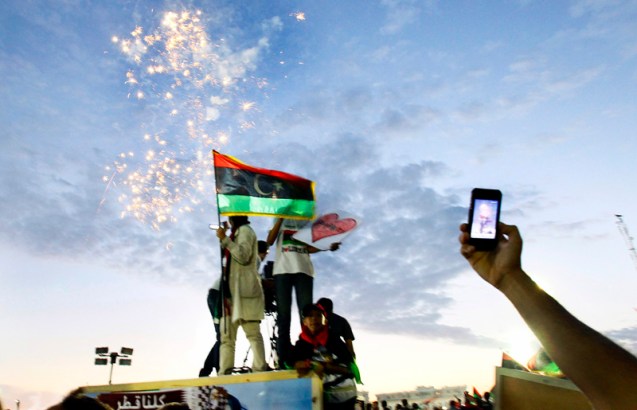 A Libyan uses his cell phone to picture fireworks amid celebrations at Saha Kish Square in Benghazi, Libya, Sunday Oct. 23, 2011 as Libya's transitional government declared the liberation of Libya after months of bloodshed that culminated in the death of longtime leader Moammar Gadhafi. © Francois Mori | AP