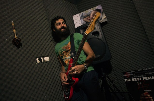 Sevan Shahmirian, a member of the underground music band "Wednesday Call" prepares for a practice session at a home music studio in Tehran, on July 7, 2011. Many Iranian bands do not bother asking for the mandatory government permits to release their music and seek contracts with foreign companies or put their music on websites blocked by the state but still accessible to anyone with a modicum of technical skill. @Reuters/Morteza Nikoubazl)