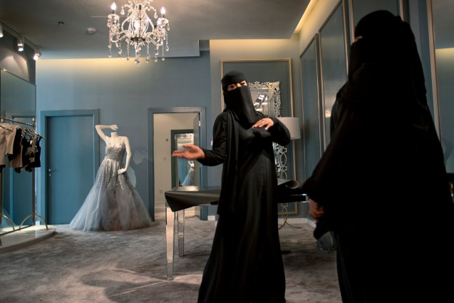 Two Saudi saleswomen in Harvey Nichols, the British luxury department store, in Riyadh. In 2011, the Ministry of Labor ordered shops specializing in cosmetics, abayas, and wedding dresses, along with the women’s sections of department stores, to begin shifting to all-female Saudi sales staffs. The process is called “feminization.” @Kate Brooks Photography | The New Yorker