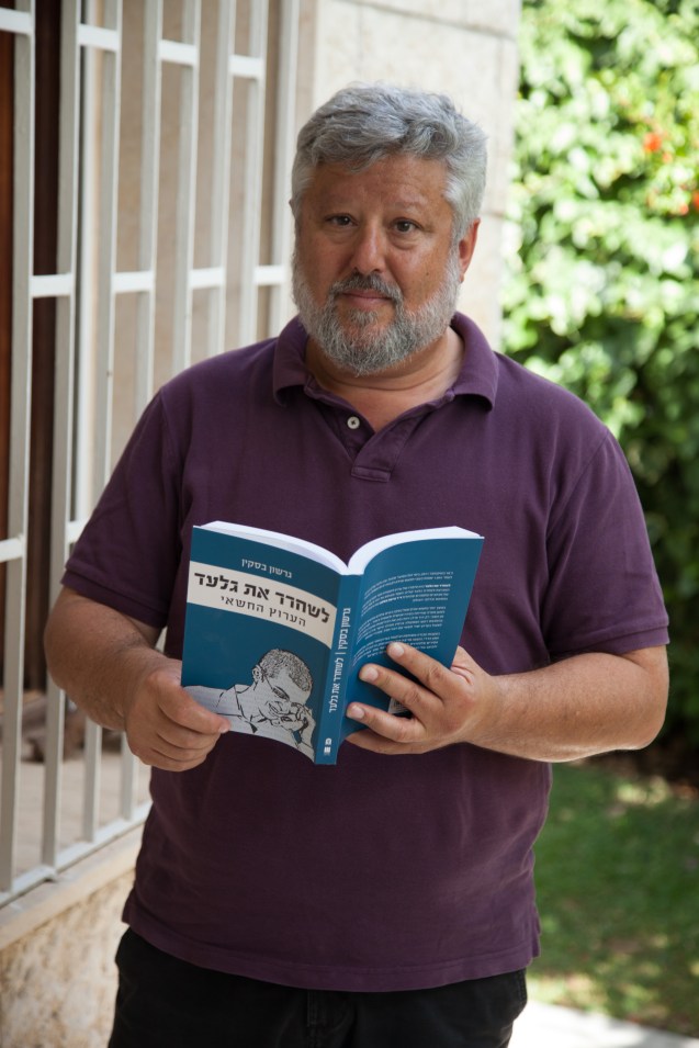 Gershon Baskin holding the original Hebrew copy of his bookThe Negotiator: Freeing Gilad Schalit from Hamas. @Udi Goren
