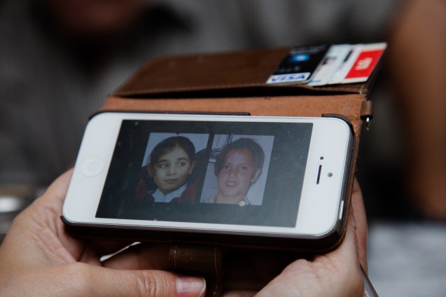 On his mobile telephone, Rami Elhanan, an active member of the Parents Circle Forum Family, shows pictures of his 14-year old daughter (on the right), who was killed by a Palestinian suicide bomber, and of the 10-year old daughter of his Palestinian friend Bassam Aramin, murdered by Israeli border police. @ Udi Goren