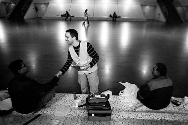 One of the six main locations served by ACA is Gare do Oriente. At least 30 homeless people, mostly men, sleep on the cold stone benches of this central railway station, which connects the north and south of Portugal. All of them are treated like relatives by the ACA helpers, who are easily identified by their green vests. On a Saturday night, Hugo Martins, a young doctor who has donated backpacks with simple medical supplies for the homeless, gives two octogenarians medical advice. One of them, a widower, owns a house but moved to the station to sleep after the love of his life died five years ago. The ACA focuses on basic needs, such as offering medical treatment free of charge, obtaining documents, or arranging for a state pension. It does not distribute soup or blankets since many other groups do that. Working with the homeless is a remarkable personal experience, Dr. Martins says. "I no longer deal solely with diseases but with human beings, who make a better person out of me," he says. @Associação Conversa Amiga