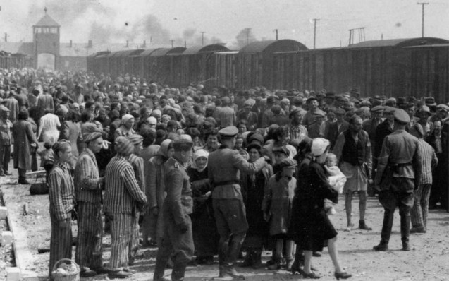 Newly arrived prisoners at Auschwitz are sorted by guards into groups of who will be sent to labour camps and who will be sent to the gas chambers. © Vashem | AP