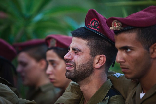 Israeli soldiers mourn during the funeral of their comrade Bnaya Rubel in Holon, near Tel Aviv © Reuters