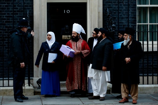 A petition is delivered to 10 Downing Street by Mrs Amarah Hannan (2nd L) and Peer Munawwar Hussain Shah (3rd L) during a protest near Downing Street in central London on February 8, 2015. Hundreds of demonstrators denounced the depictions of the Prophet Muhammad printed in the French satirical magazine Charlie Hebdo, on a day when, in an interview to be broadcast Sunday, Britain's Prince Charles said the numbers of vulnerable young Muslims being radicalised by "crazy stuff" on the Internet was "frightening". © AFP 