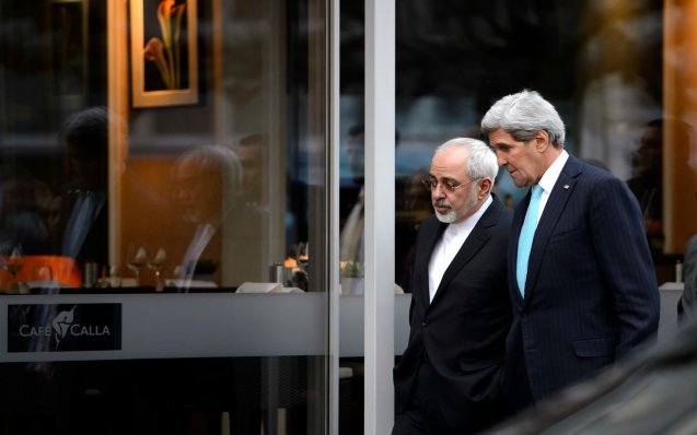 FILE - In this file photo taken Wednesday, Jan. 14, 2015, U.S. Secretary of State John Kerry, right, speaks with Iranian Foreign Minister Mohammad Javad Zarif as they walk in Geneva, Switzerland, ahead of the next round of nuclear discussion. Zarif has borne the brunt of the hard-liners' most recent criticism, particularly over a walk he took with Kerry during negotiations in Geneva in January 2015. © Keystone, Martial Trezzini |AP