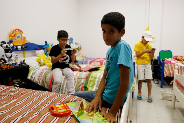 Three of the seven children of the Darwish family playing in their room in the community center: the people of Nazareth were very generous in their donations © Marisol González