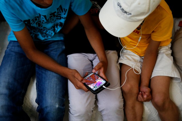 The mobile phone helps the family to communicate with relatives back in Syria but also to listen to the adhaan, the call to the five daily Muslim prayers © Marisol González